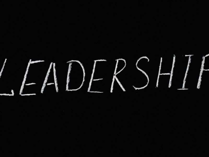 Chalk text spelling 'Leadership' on a blackboard, symbolizing guidance and authority.